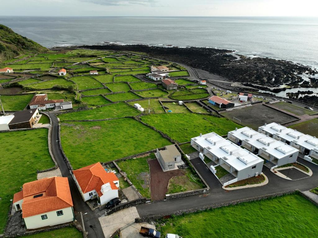 an aerial view of a village next to the ocean at Casa do Sol Posto in Faja Grande
