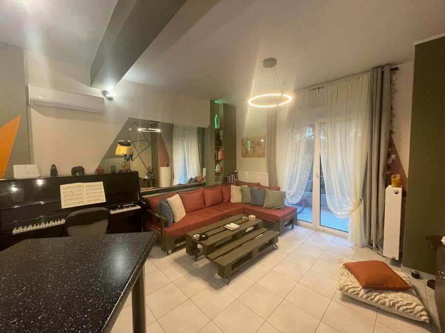 a living room with a couch and a piano at Seaside apartment in Athens