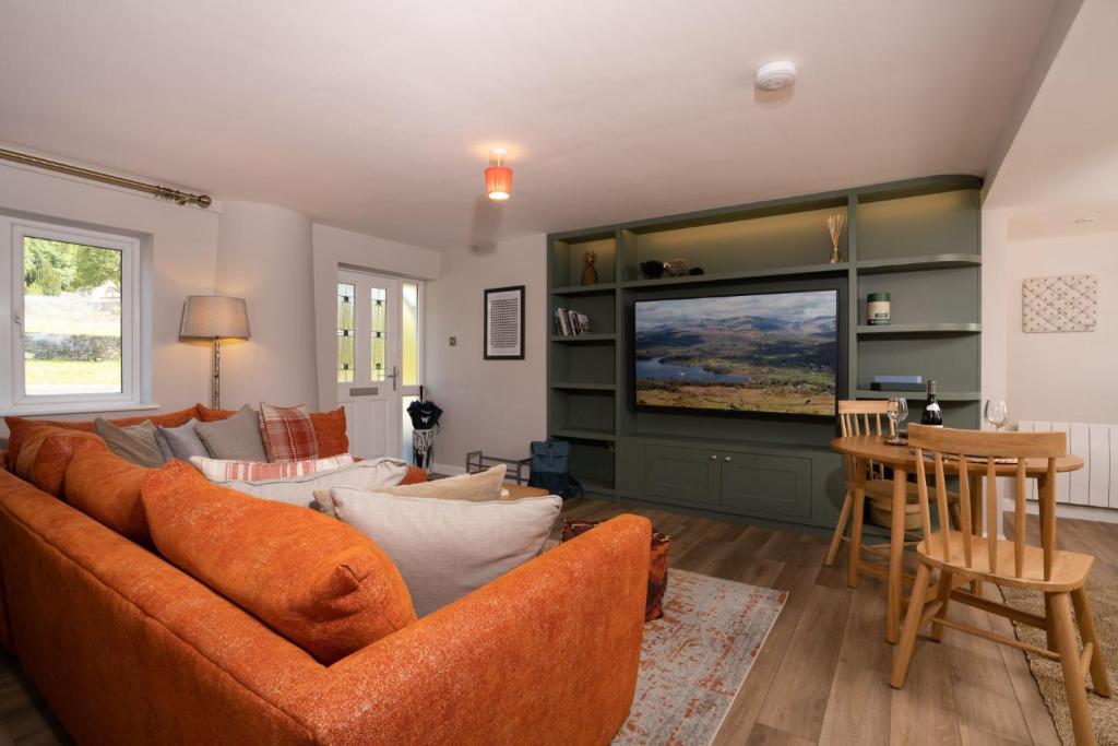 a living room with a couch and a tv at Contemporary Home with Parking by LetMeStay in Kendal