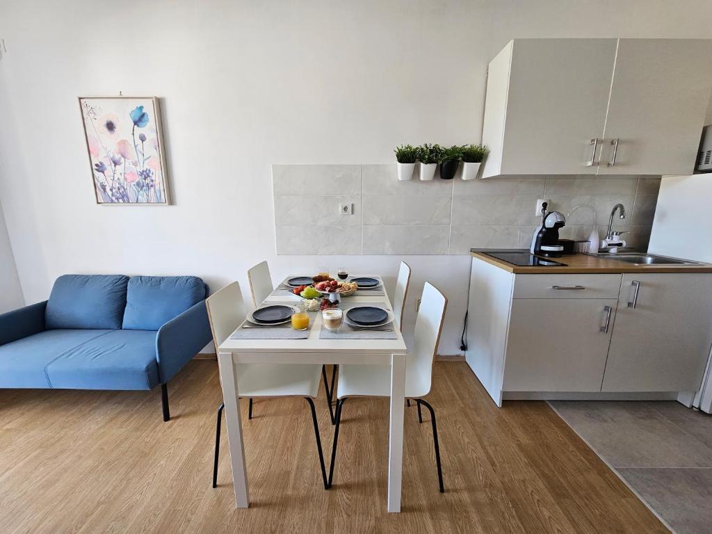 a white table and chairs in a small kitchen at Studio apartment PEGY in Vir