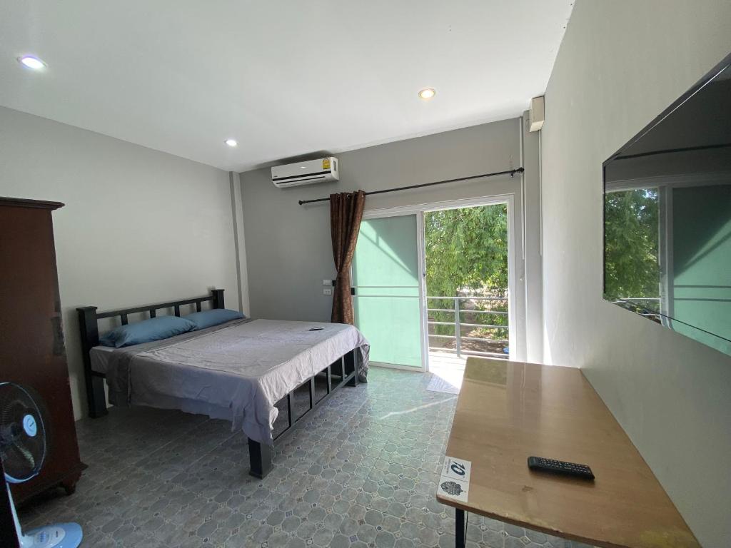 a bedroom with a bed and a sliding glass door at Кондо в райском уголке Равай in Rawai Beach