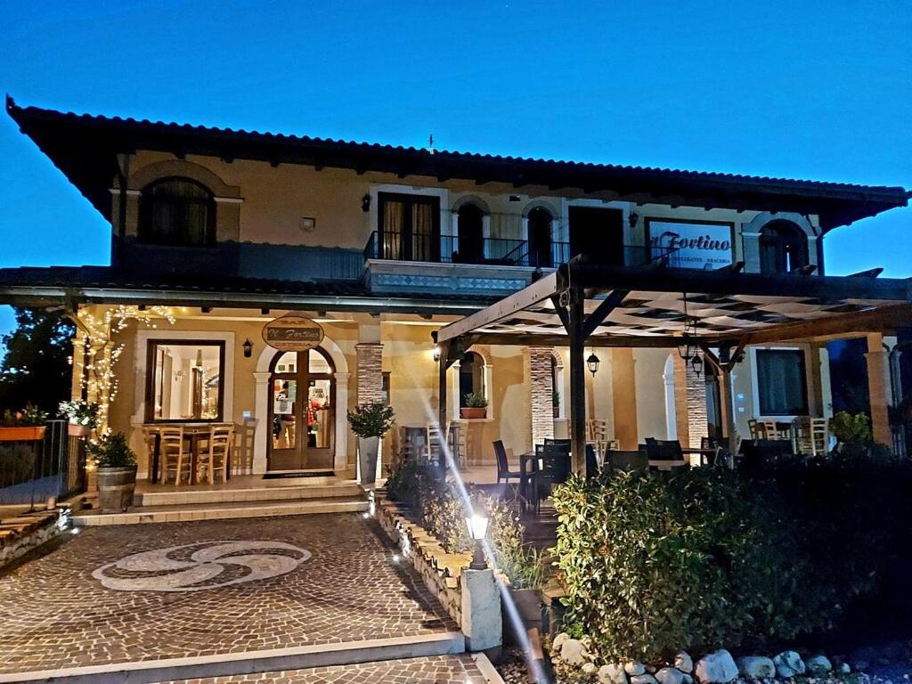 a large house with an umbrella in front of it at Il Fortino in Celano