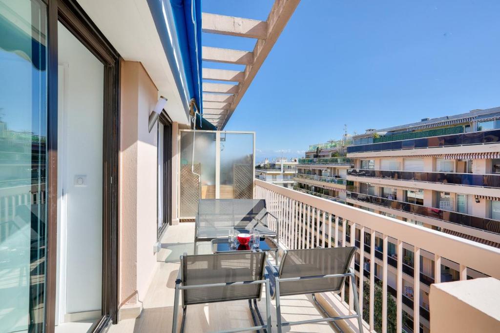 un balcon avec une table et des chaises sur un immeuble dans l'établissement LE BALZAC T3 centre ville proche toutes commodités, à Antibes