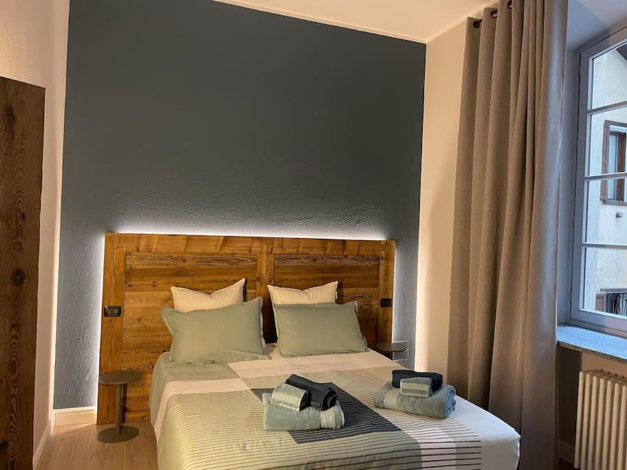 a bedroom with a bed with two towels on it at Creton apartment -La casa nel cuore della città- CIR 0121 in Aosta