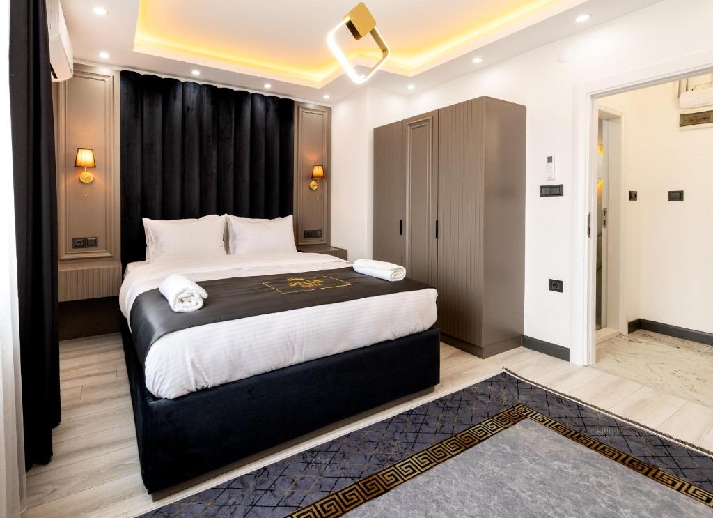 a bedroom with a large bed with black curtains at Selia SUİTES in Trabzon