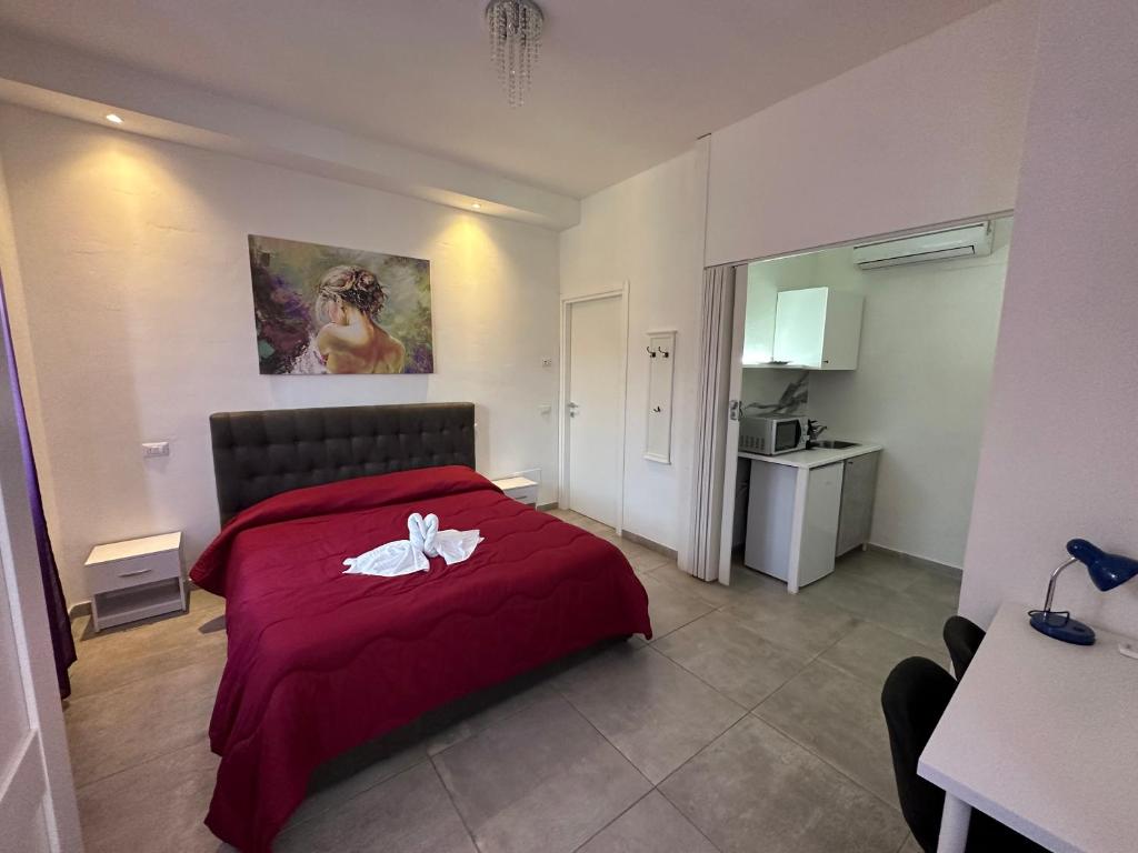 a bedroom with a red bed with a flower on it at B&B La Magnolia in Caprino Veronese