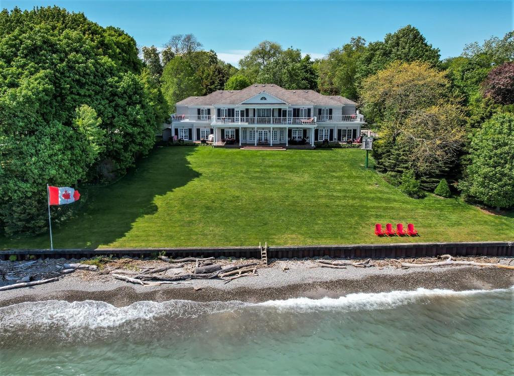 an aerial view of a large house on the water at Somerset - A Private Retreat in Niagara-on-the-Lake