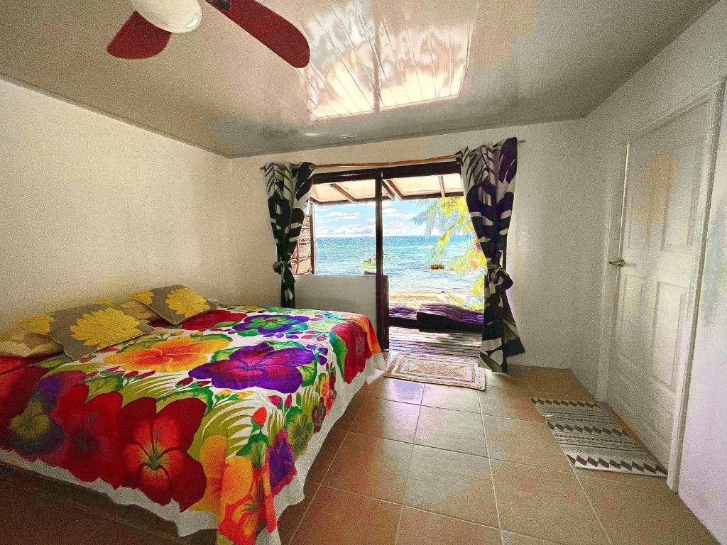 - une chambre avec un lit et une vue sur l'océan dans l'établissement Tikehau cosy lodge, à Tikehau