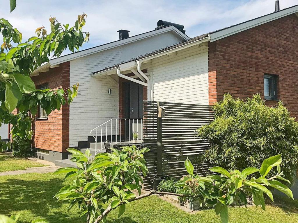 a brick house with a porch and a door at 5 person holiday home in BANKERYD in Bankeryd