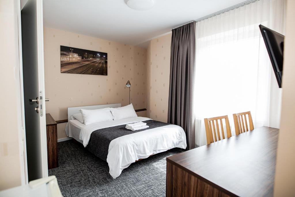 Postel nebo postele na pokoji v ubytování Hotel Tomas