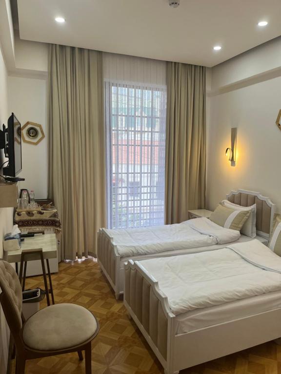 Postel nebo postele na pokoji v ubytování LUXIN