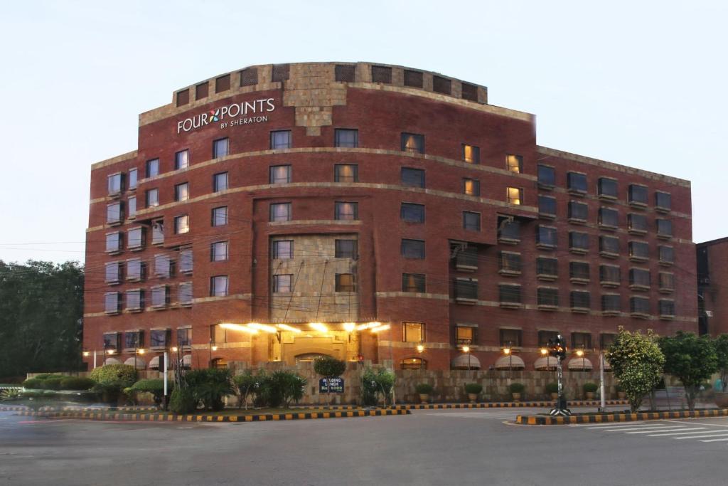 a large red brick building with a sign on it at Four Points by Sheraton Lahore in Lahore