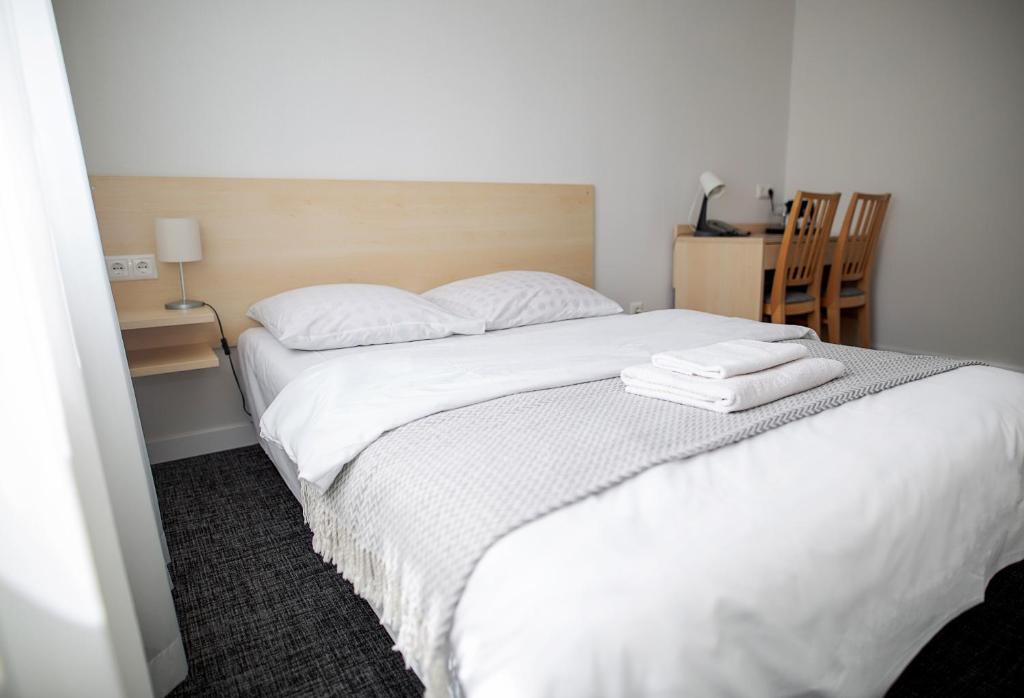 Postel nebo postele na pokoji v ubytování Hotel Tomas