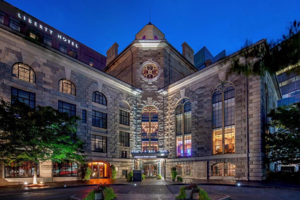 a large building with a lit up facade at night at The Liberty, a Luxury Collection Hotel, Boston in Boston