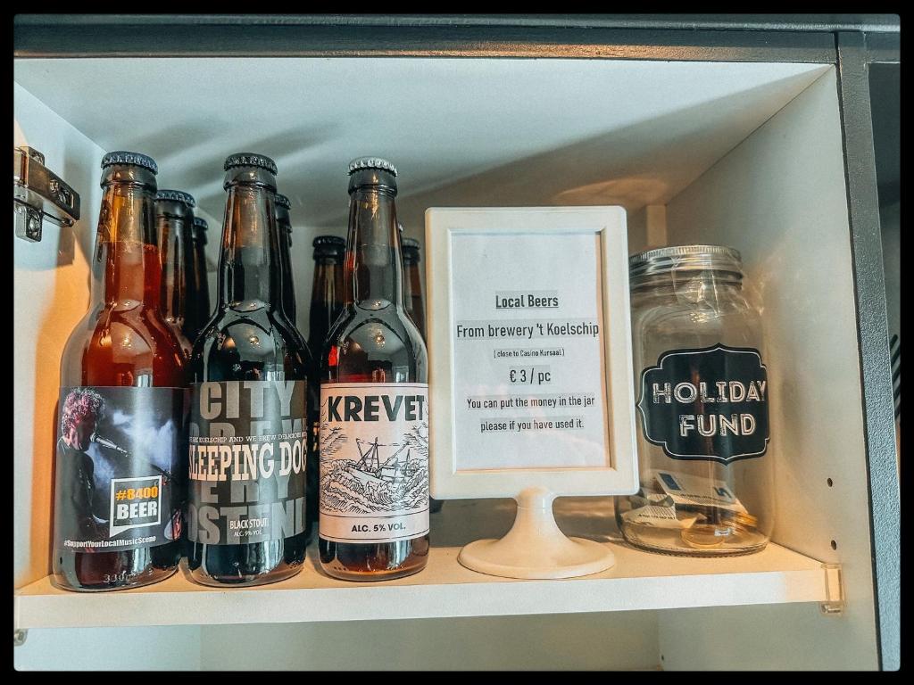 a shelf with a bunch of bottles of beer at CASA MARE hartje Oostende met gratis parking in Ostend