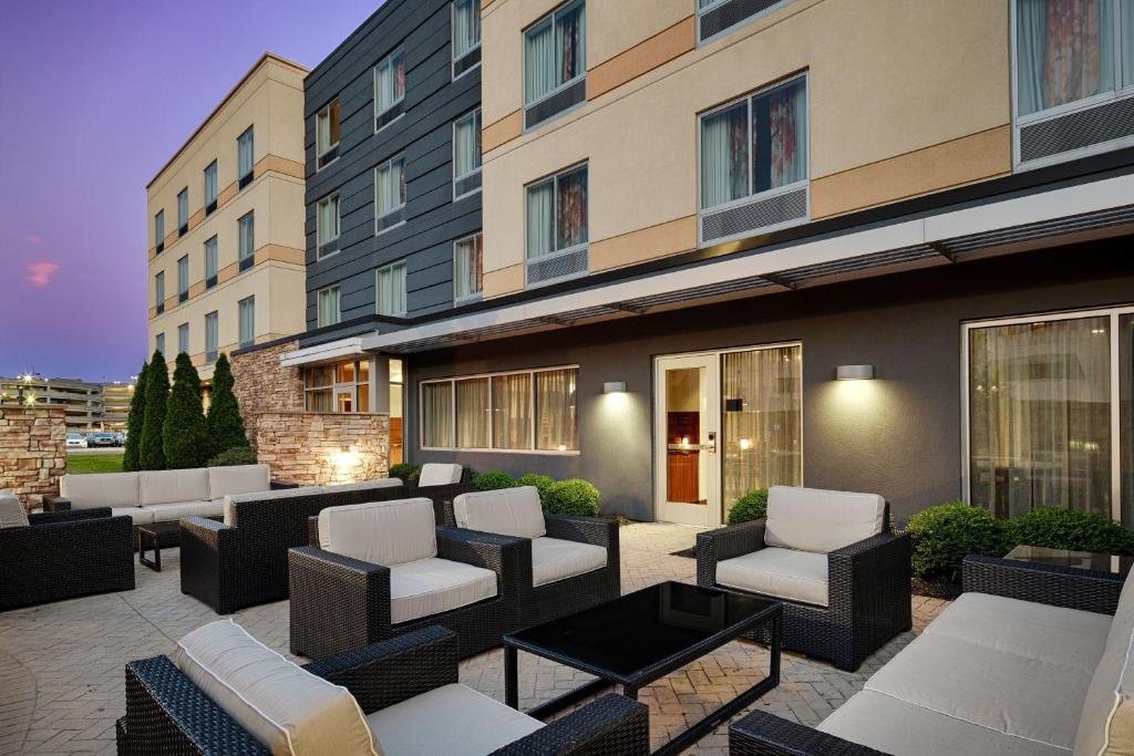 a patio with chairs and tables in front of a building at Fairfield Inn & Suites by Marriott Columbus Airport in Columbus