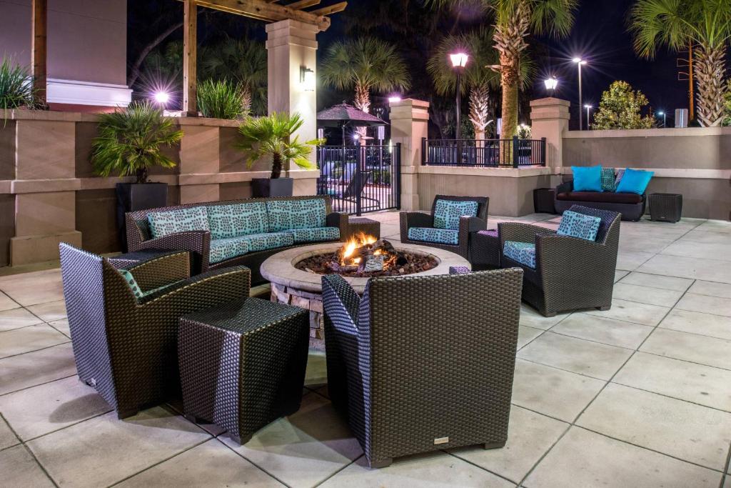a patio with chairs and a fire pit in the middle at Residence Inn Gainesville I-75 in Gainesville