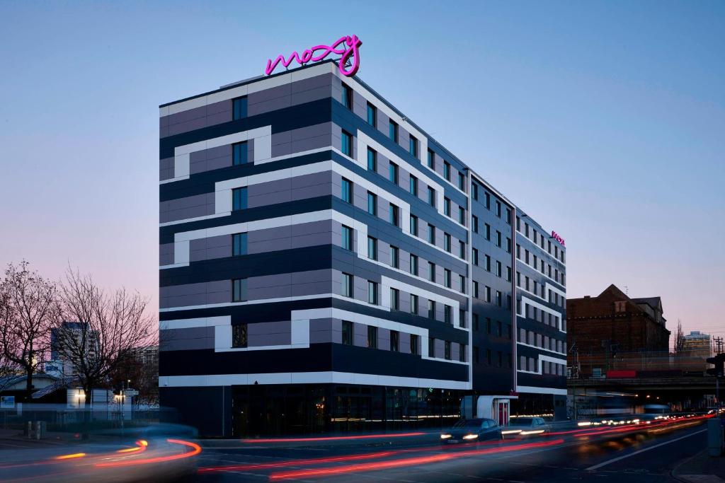 a building with a msg sign on top of it at Moxy Berlin Ostbahnhof in Berlin