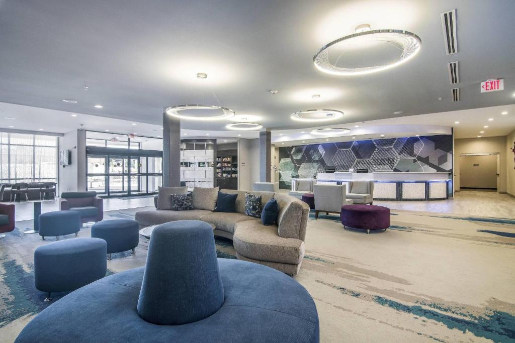 a living room with couches and chairs in a building at SpringHill Suites by Marriott Oklahoma City Downtown in Oklahoma City