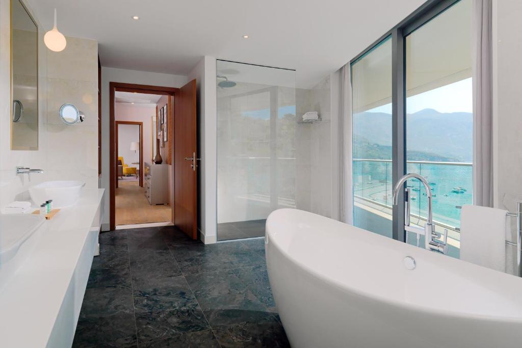 a bathroom with two sinks and a bath tub at Sheraton Dubrovnik Riviera Hotel in Mlini