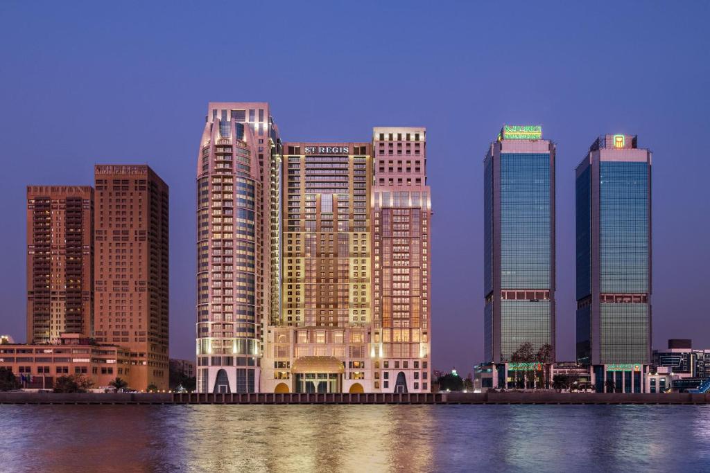 a group of tall buildings next to a body of water at The St. Regis Cairo in Cairo
