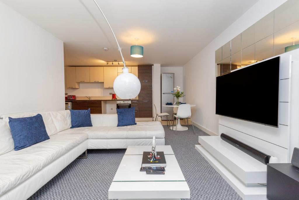 a living room with a white couch and a flat screen tv at Right Place in London