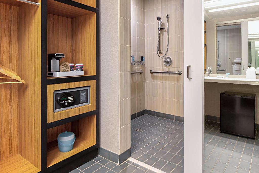 a bathroom with a shower and a sink at Aloft Dallas Downtown in Dallas