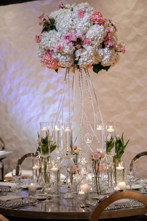 a table with a vase of flowers and candles at Aloft Dallas Downtown in Dallas