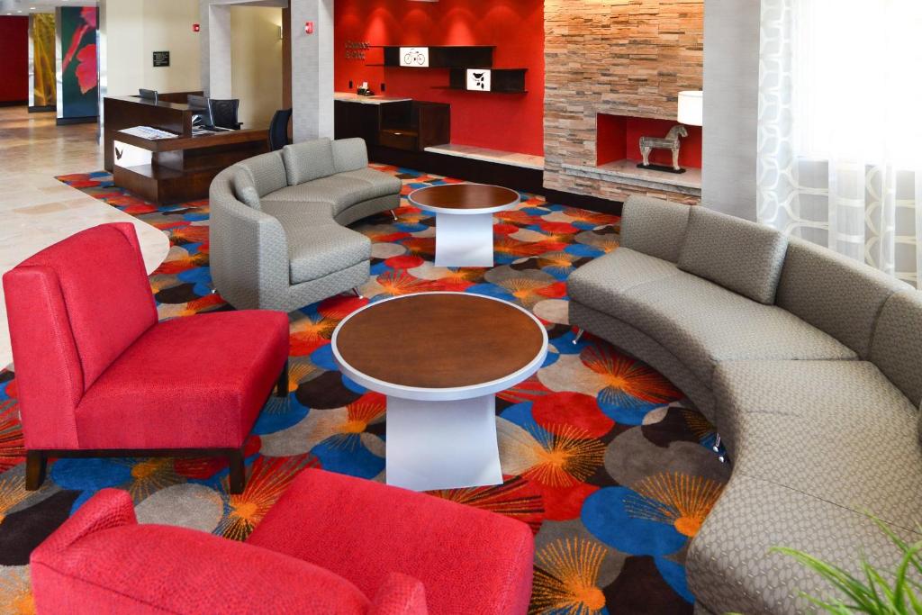 a lobby with couches and chairs and a table at Fairfield Inn and Suites by Marriott North Spring in Spring