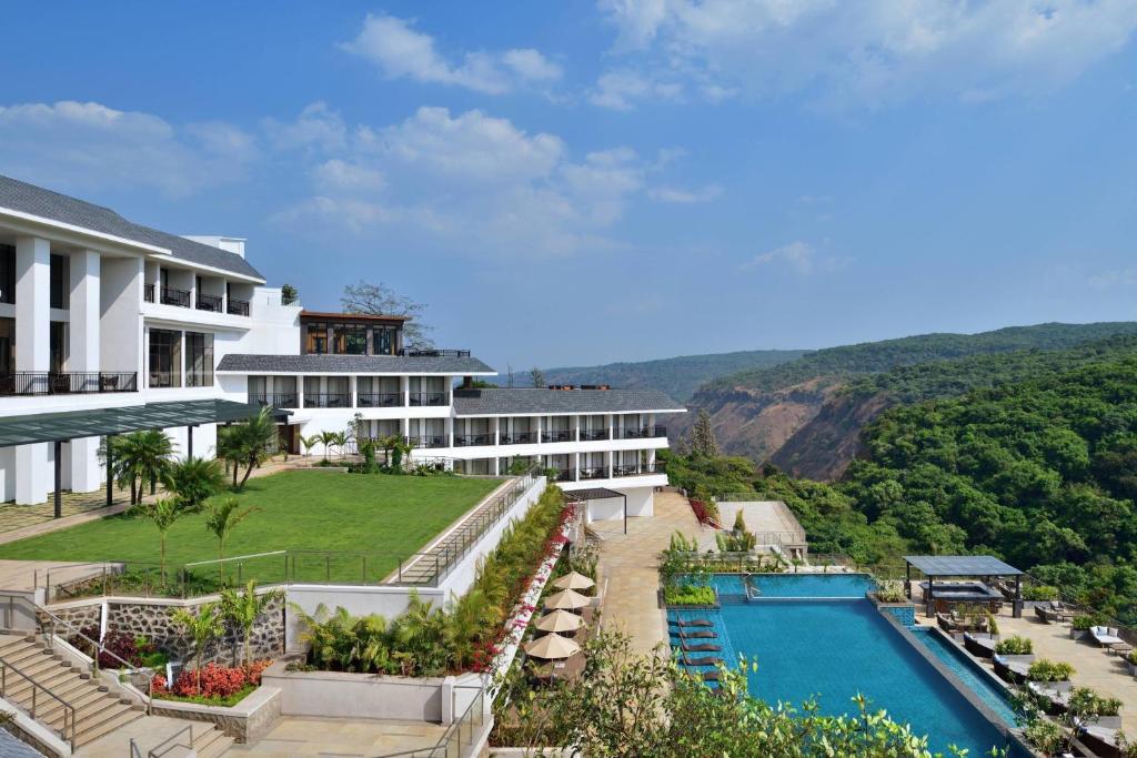 an aerial view of a resort with a swimming pool at Courtyard by Marriott Mahabaleshwar in Mahabaleshwar