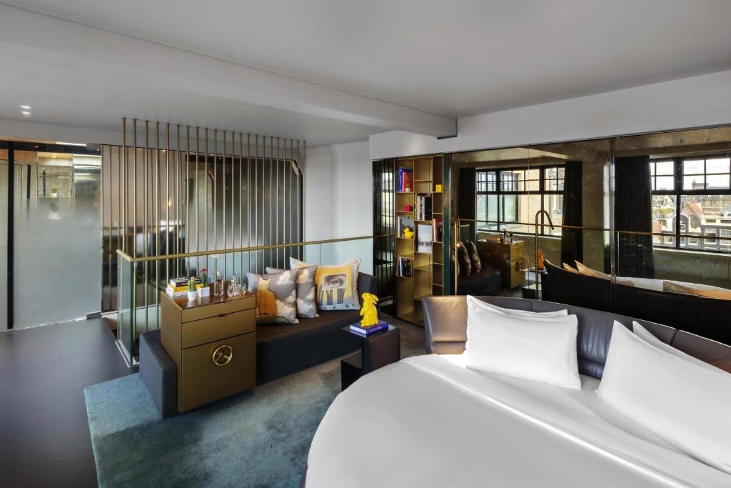 a hotel room with a bed and a couch at W Amsterdam in Amsterdam
