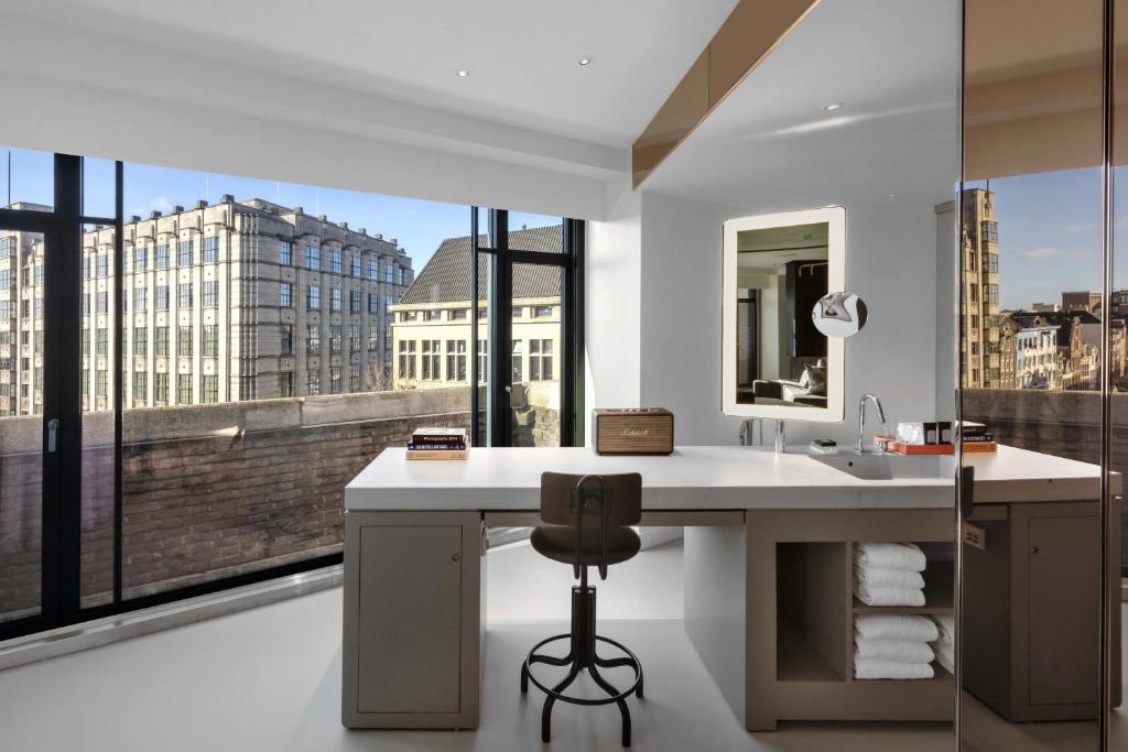 a bathroom with a sink and a large window at W Amsterdam in Amsterdam