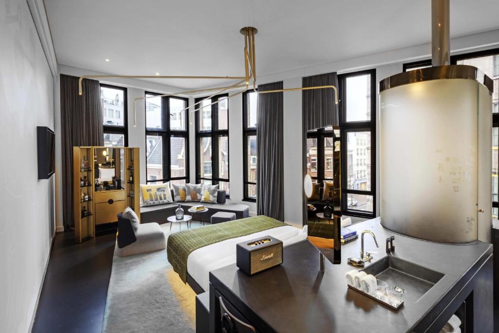 a bedroom with a bed and a sink in a room at W Amsterdam in Amsterdam