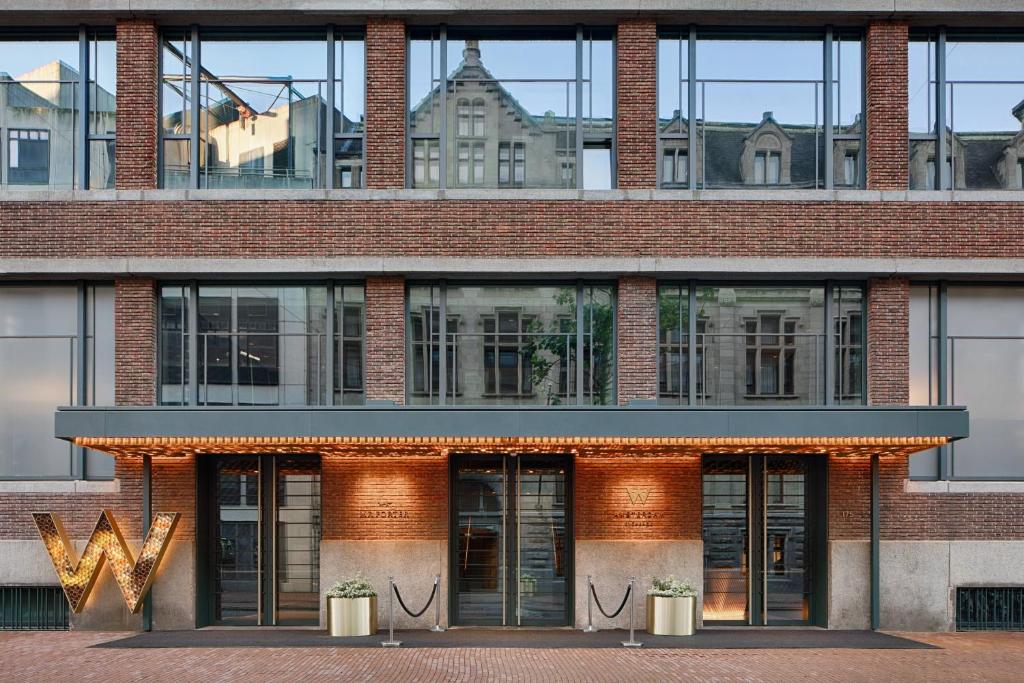 a tall brick building with doors and windows at W Amsterdam in Amsterdam