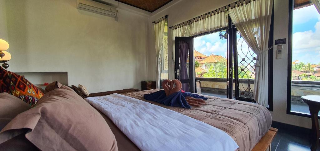 Postel nebo postele na pokoji v ubytování Kun - Kun Guest House Ubud