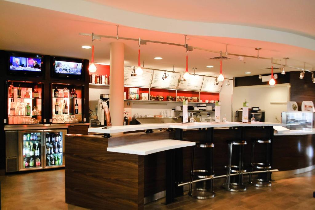 a bar in a restaurant with a counter and stools at Courtyard Salina in Salina