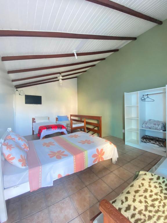 a bedroom with two beds in a room at Barra da Lagoa Guest House in Florianópolis