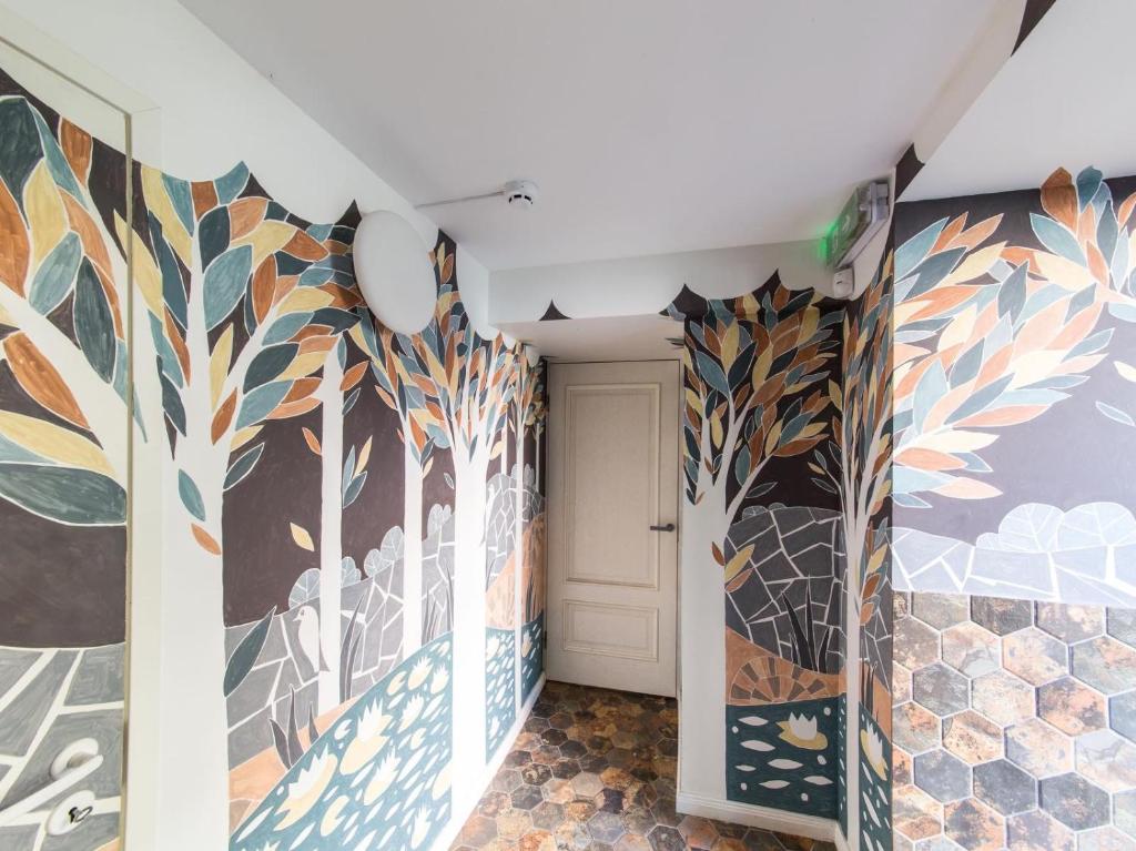 a hallway with colorful murals on the walls at Avers House in Narva