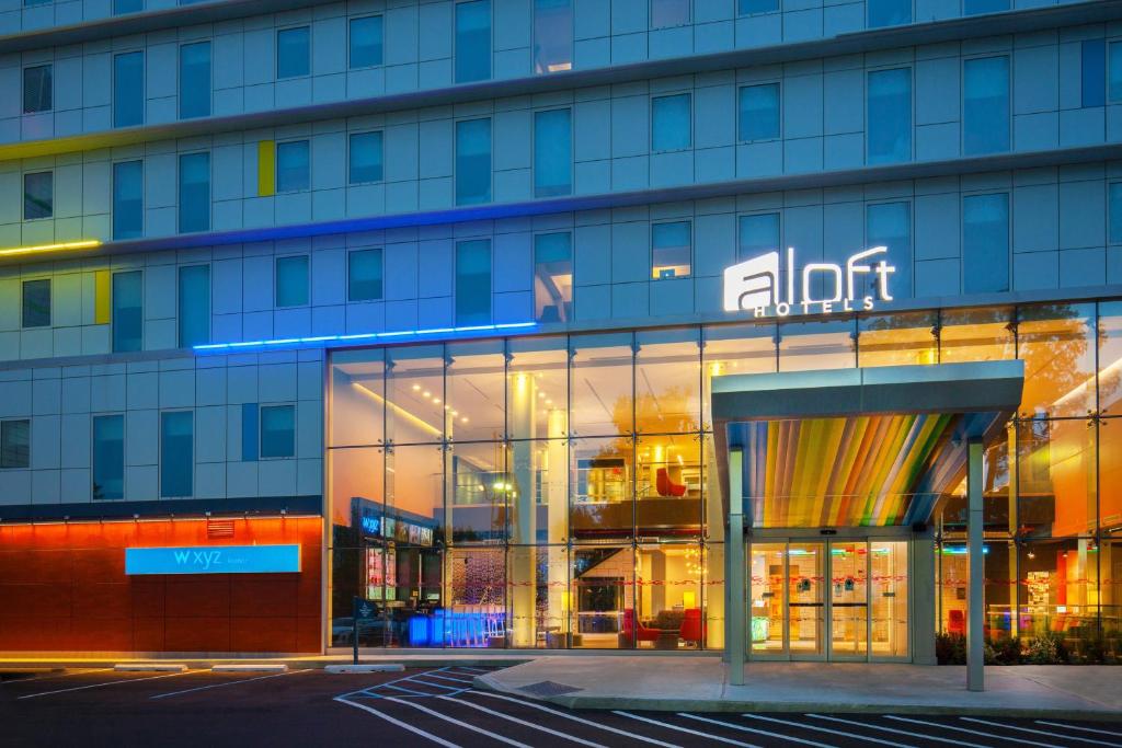 a building with a sign on the front of it at Aloft New York LaGuardia Airport in Queens