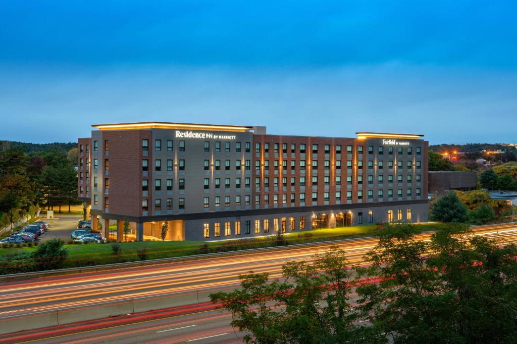 a large building with a highway in front of it at Fairfield Inn & Suites by Marriott Boston Waltham in Waltham
