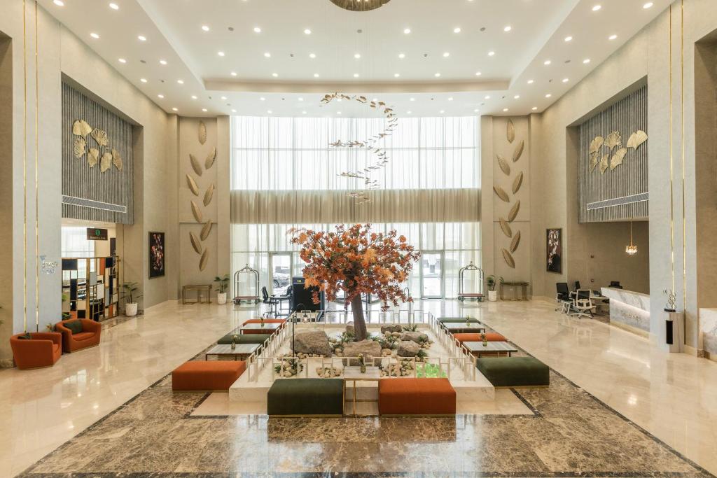 a lobby with a fountain in the middle of a building at Tolip Resort Sunrays New- Alamein in El Alamein