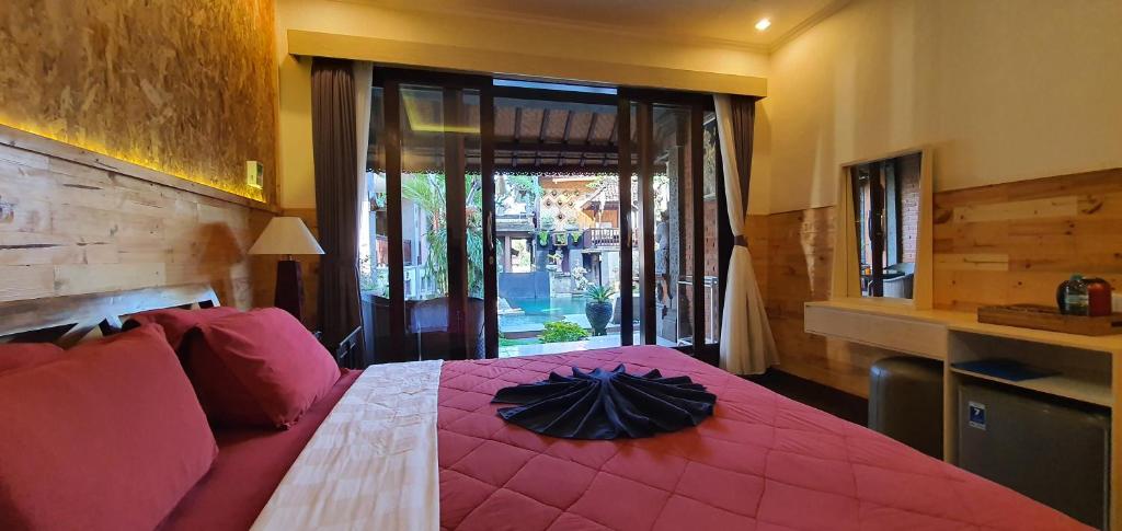 Postel nebo postele na pokoji v ubytování Kun - Kun Guest House Ubud