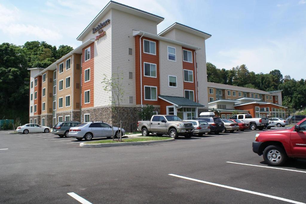un estacionamiento con autos estacionados frente a un edificio en Residence Inn Pittsburgh Monroeville/Wilkins Township, en Monroeville