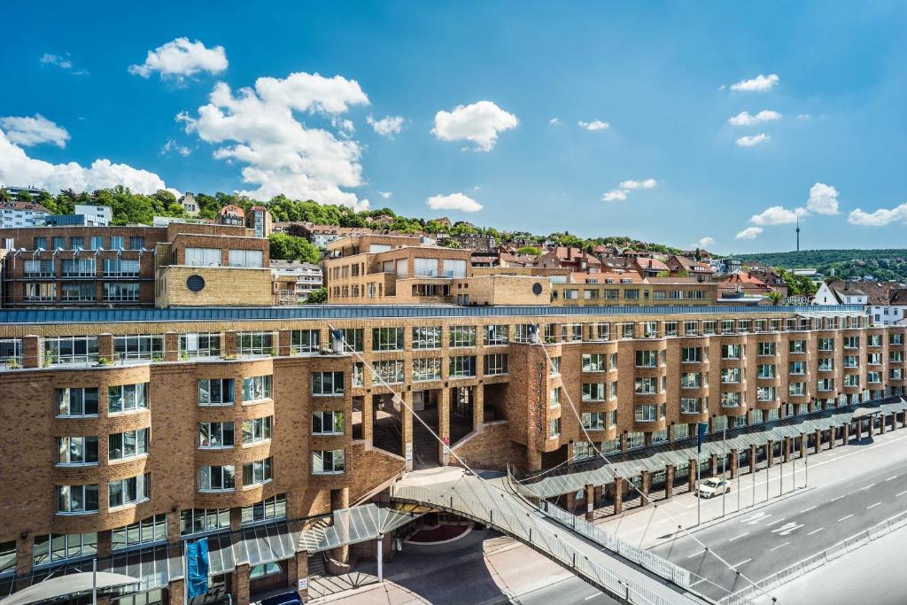 a bridge over a street in a city with buildings at Le Méridien Stuttgart in Stuttgart