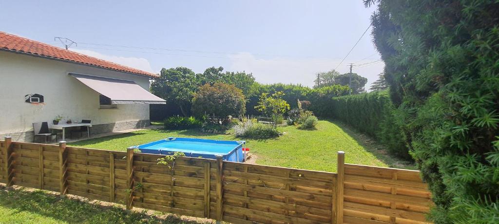 a backyard with a wooden fence and a swimming pool at L’échappée Belle in Culmont
