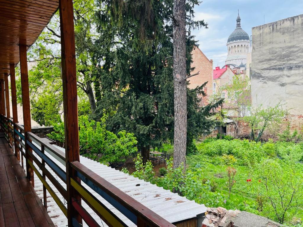a porch with a view of a garden and a building at Central Hostel Cluj in Cluj-Napoca