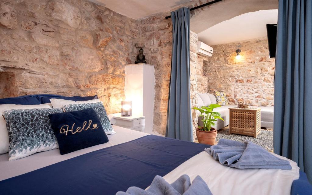 a bedroom with a bed in a stone wall at Heritage Stone House Retreat -Free parking in Stari Grad
