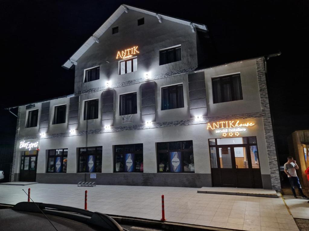 a white building with lights on the side of it at ANTIK HOUSE in Cornu de Jos