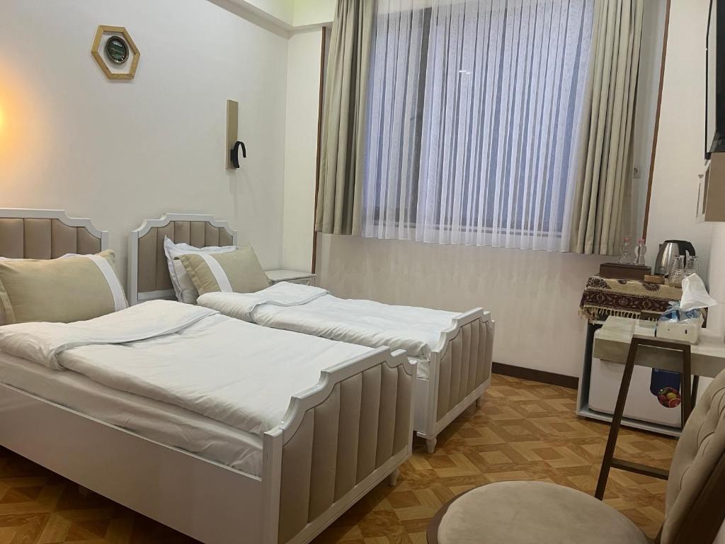 Postel nebo postele na pokoji v ubytování LUXIN