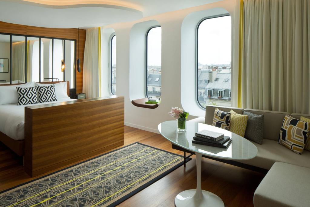 a hotel room with a bed and a table at Renaissance Paris Republique Hotel & Spa in Paris